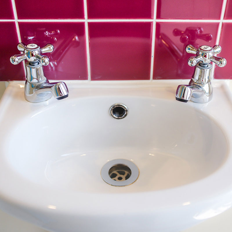 A Posh Wash hand basin with ceramic tiles, sink and real taps A 5 Bay Posh Wash Shower Unit